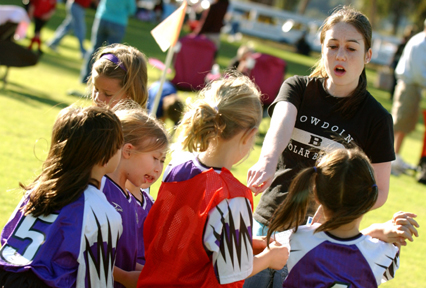 Danielle Rochlin points to where she wants her Purple Pineapples to be during a game. Besides coaching AYSO, Rochlin plays on the Palisades High varsity team.