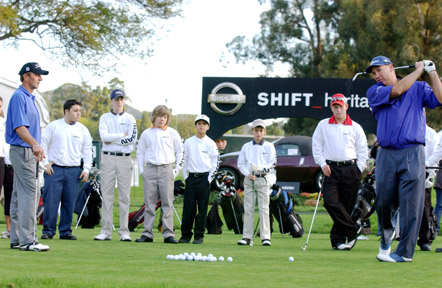 Duffy Waldorf (far right) smacks a drive down the middle of the fairway during a youth clinic at Riviera Country Club's 14th hole Monday morning in anticipation of the 2006 Nissan Open.