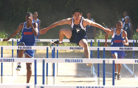 Sophomore Jeff Fujimoto (center) remained undefeated in the 110 high hurdles, finishing first in 17.6 last Friday against University.