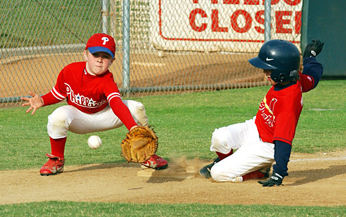 Cardinal Jack Halper slides safely into third ahead of the tag from Alec Dodson of the Phillies