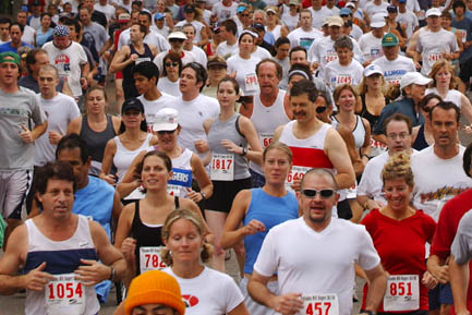 Runners cross the starting line at the corner of Alma Real and Toyopa Drives to begin last year's Palisades-Will Rogers 5K/10K race.