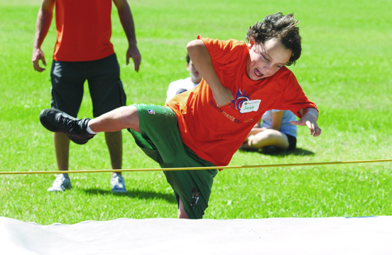 Sixth-grader Josh Modabber leaps to complete the high jump.