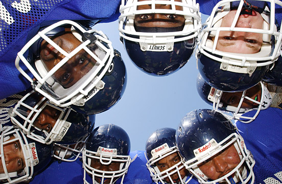 Palisades High football players huddle up to discuss an offensive play during practice on Monday.