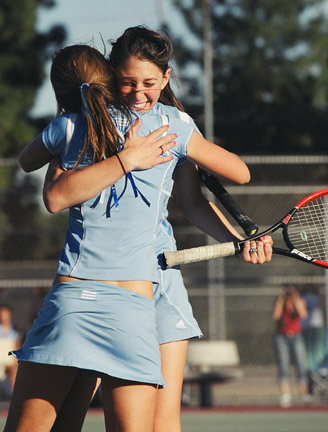 Sarah Yankelevitz (facing) hugs doubles partner Sarah Jurick after their comeback win completed the Dolphins' 6-1 victory over Carson.