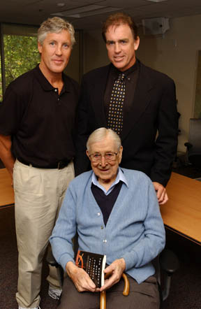 USC football coach Pete Carroll (left) and Palisadian Jeff Fellenzer (right) with legendary UCLA basketball coach John Wooden during a reception at the Annenberg School of Journalism.
