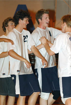 Brett Vegas (left) and Nash Petrovic (center) celebrate a kill with setter Rusty Barneson during Tuesday nightÃÂ½s City playoff match.