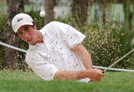 Palisades High golfer Jimmy Nissin blasts out of a sand trap on Monday in the first round of the City Section championships at Griffith Park's Harding Course. The Dolphins finished third overall.