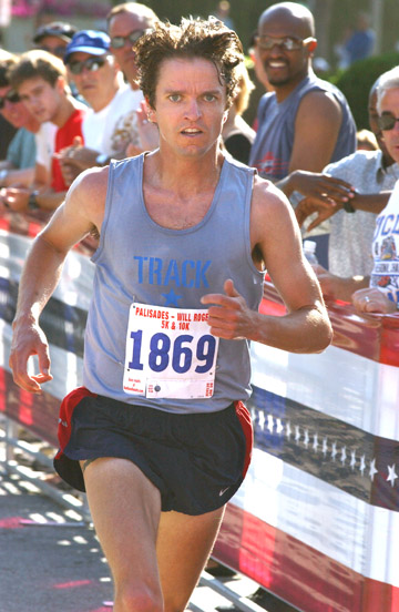 Palisadian Peter Gilmore speeds toward the finish line at the entrance to the Palisades Recreation Center, moments from 	winning the 5K race for the eighth time.