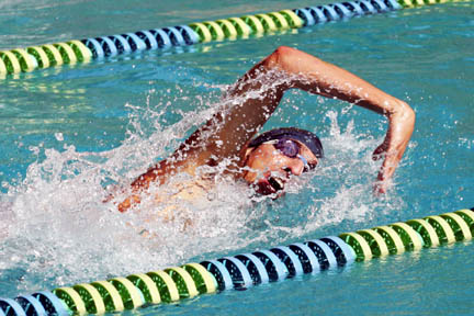 Slava Agafonoff (left) churns through the water during his 200 freestyle race while Palisades teammate Alex Ehrgott (right) shows textbook form in the 100 breaststroke at Temescal Canyon pool. Photos by Randy Nonberg