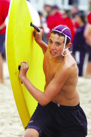 Zach Senator of Pacific Palisades heads for the water in the Taplin Relays at Dockweiler Beach. Senator's Will Rogers 'A' team finished first in the B Division.     Rich Schmitt/Staff Photographer