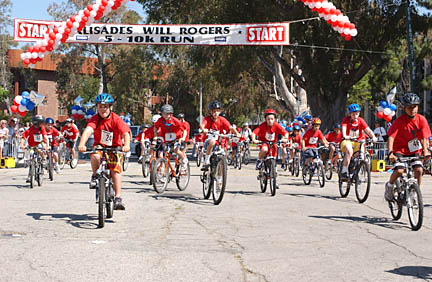 Kids pedal their bikes down Alma Real Drive to begin last year's first annual YMCA Youth Triathlon. Registration is underway for Sunday's sequel at the Palisades Recreation Center.