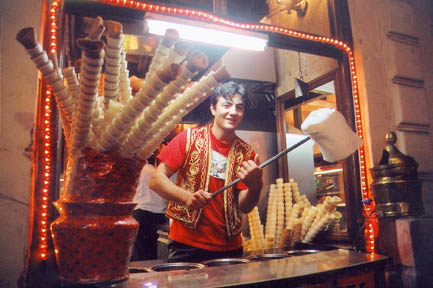 In Istanbul's lively Beyoglu area, a Turkish man in festive dress playfully sells ice cream to passers-by. Photo: Alyson Sena