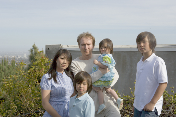 The Zabrucky family, who have lived on Turquesa Lane in Marquez Knolls since 1993, stand in front of the McAdams residence, which is now partially blocking their ocean view.