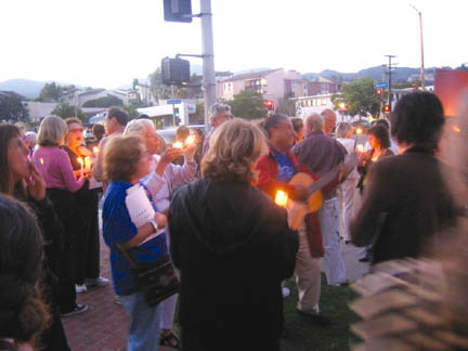 Supporters of Cindy Sheehan stand on the Village Green with candles and guitars last Wednesday. Photo: Nikila Sri-Kumar