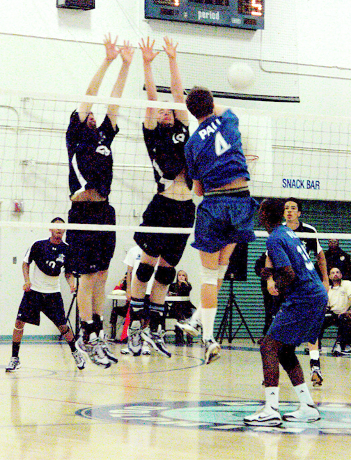 Matt Hanley (#4) spikes through two Sylmar blockers in Palisades' four-game loss last Friday night. Photo: Chuck Cohen