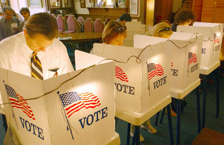 Voters ponder the lengthy ballot initiatives in the privacy of their illuminated voting cubicles at MortÃÂ½s Oak Room.