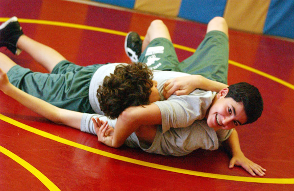 Paul Revere eighth-grader Georgie Chacbazov looks up to see if the referee considers opponent Sam Greenberg pinned during practice at the campus gym.